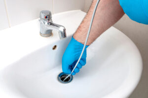 plumber unclogging a drain