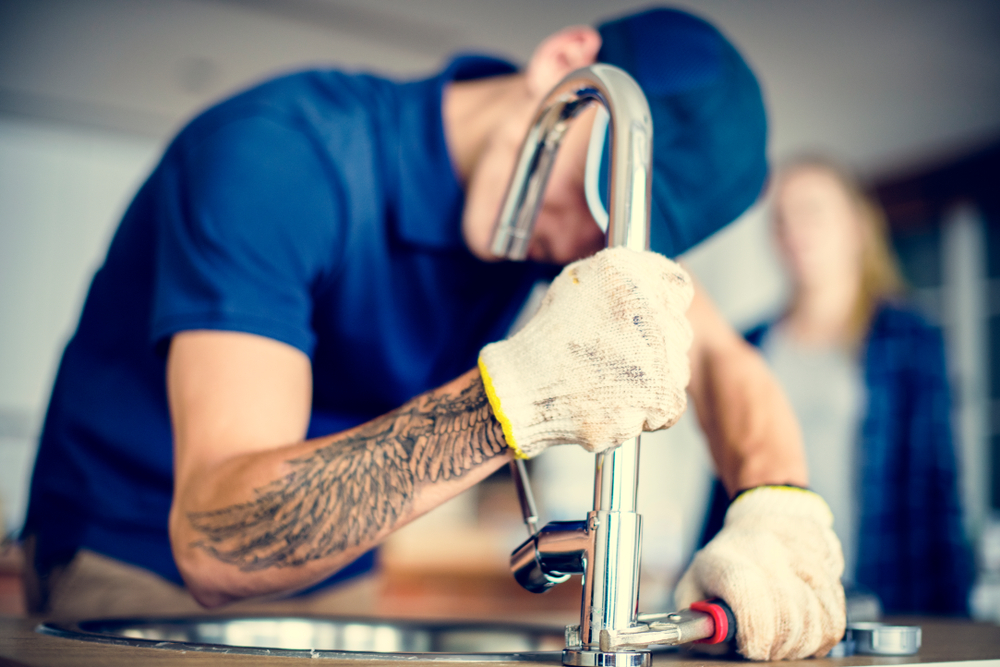 a plumber fixing a sink, representing reliable plumbing services in Orlando, FL