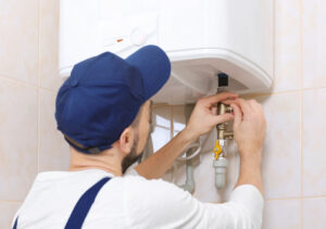 Plumber installing a new water heater for a homeowner.